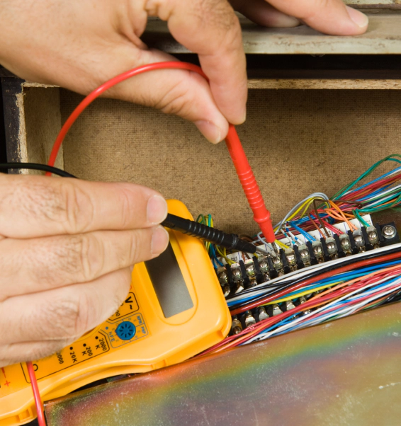 man testing voltage using voltmeter